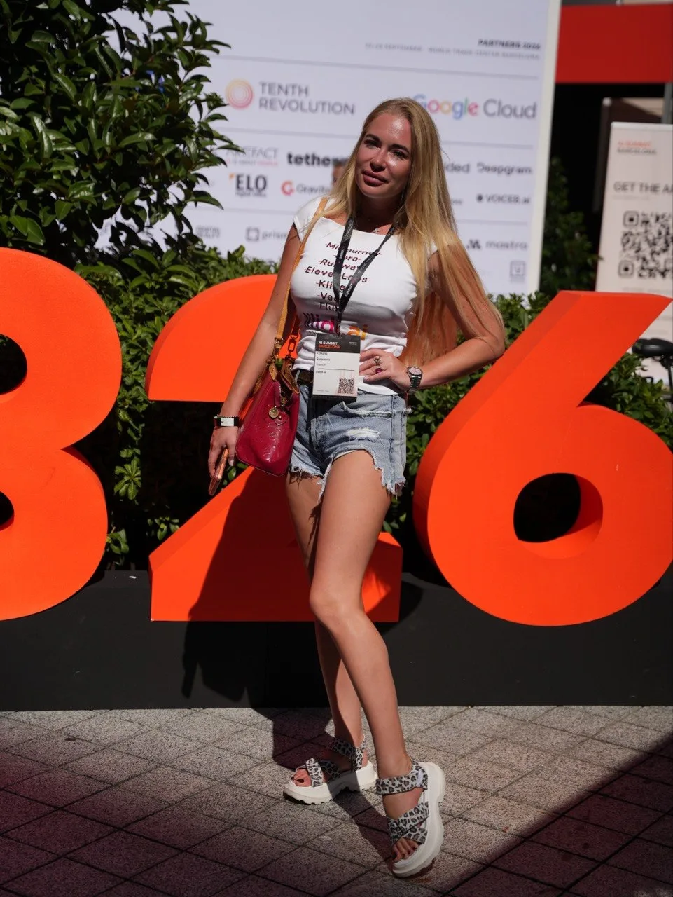 Tetiana Stepanets in front of the giant orange 2026 letters and the AI Summit Barcelona partners wall
