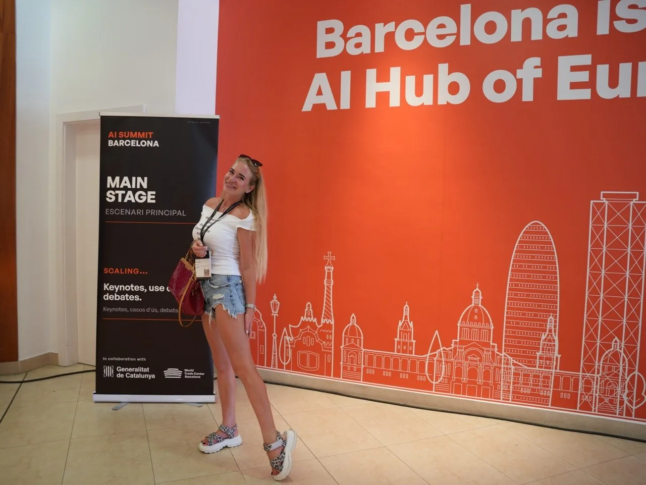 Tetiana Stepanets beside the AI Summit Barcelona Main Stage sign in front of a wall reading Barcelona is the AI Hub of Europe